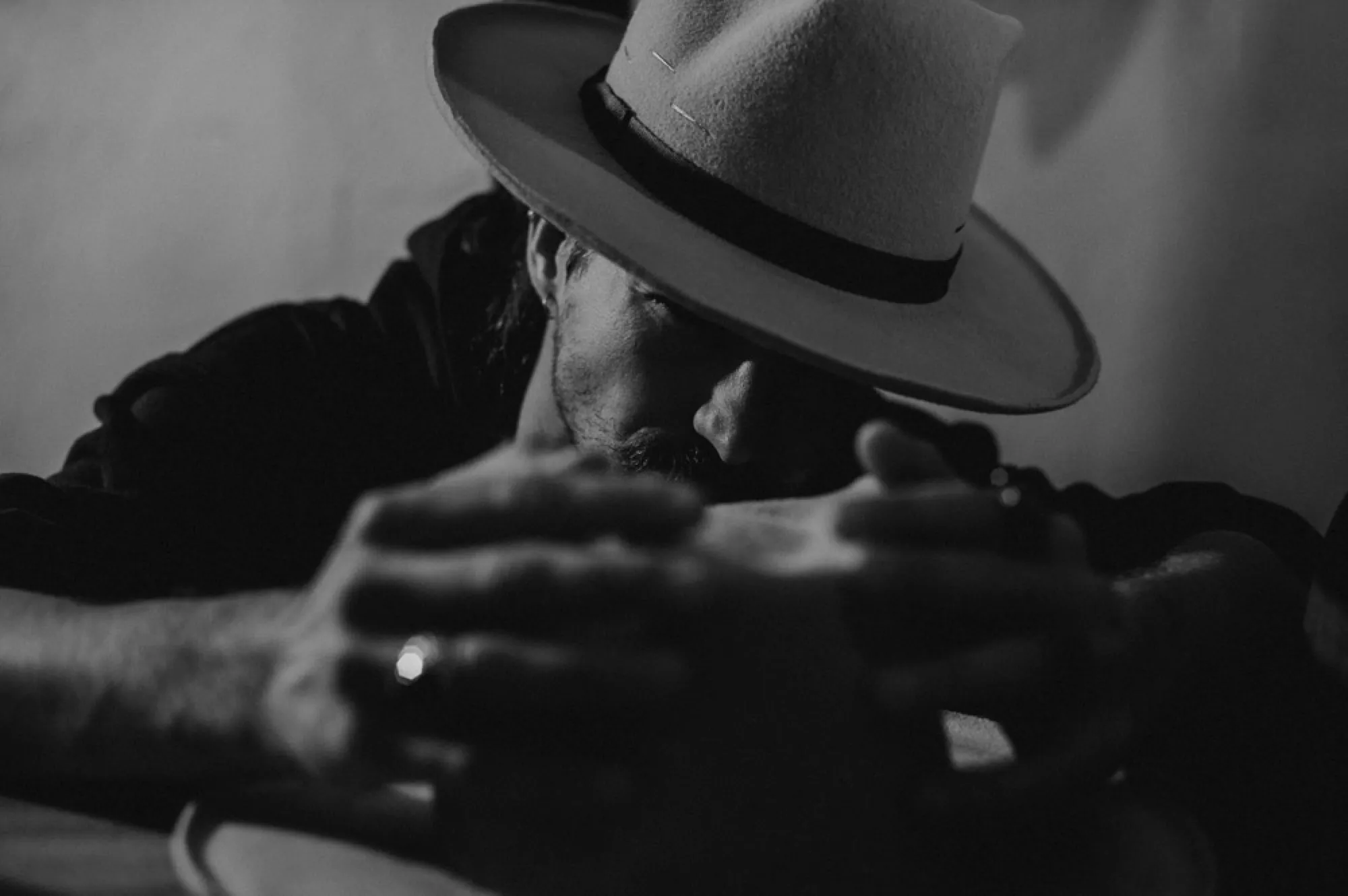 Hands smoothing the brim of a finished hat
