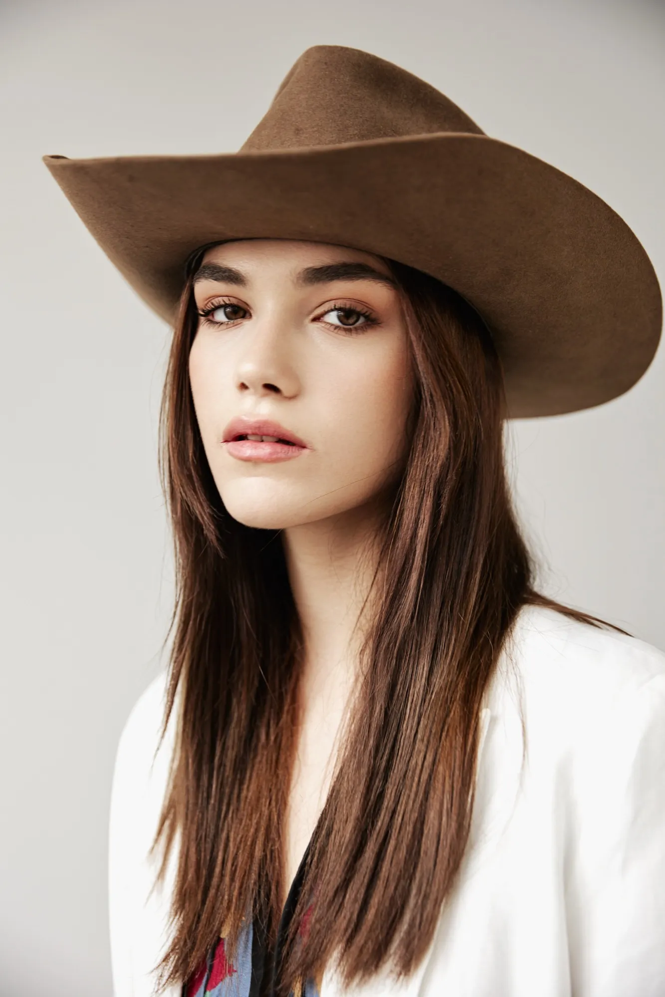 Woman with long hair in a wide brown hat