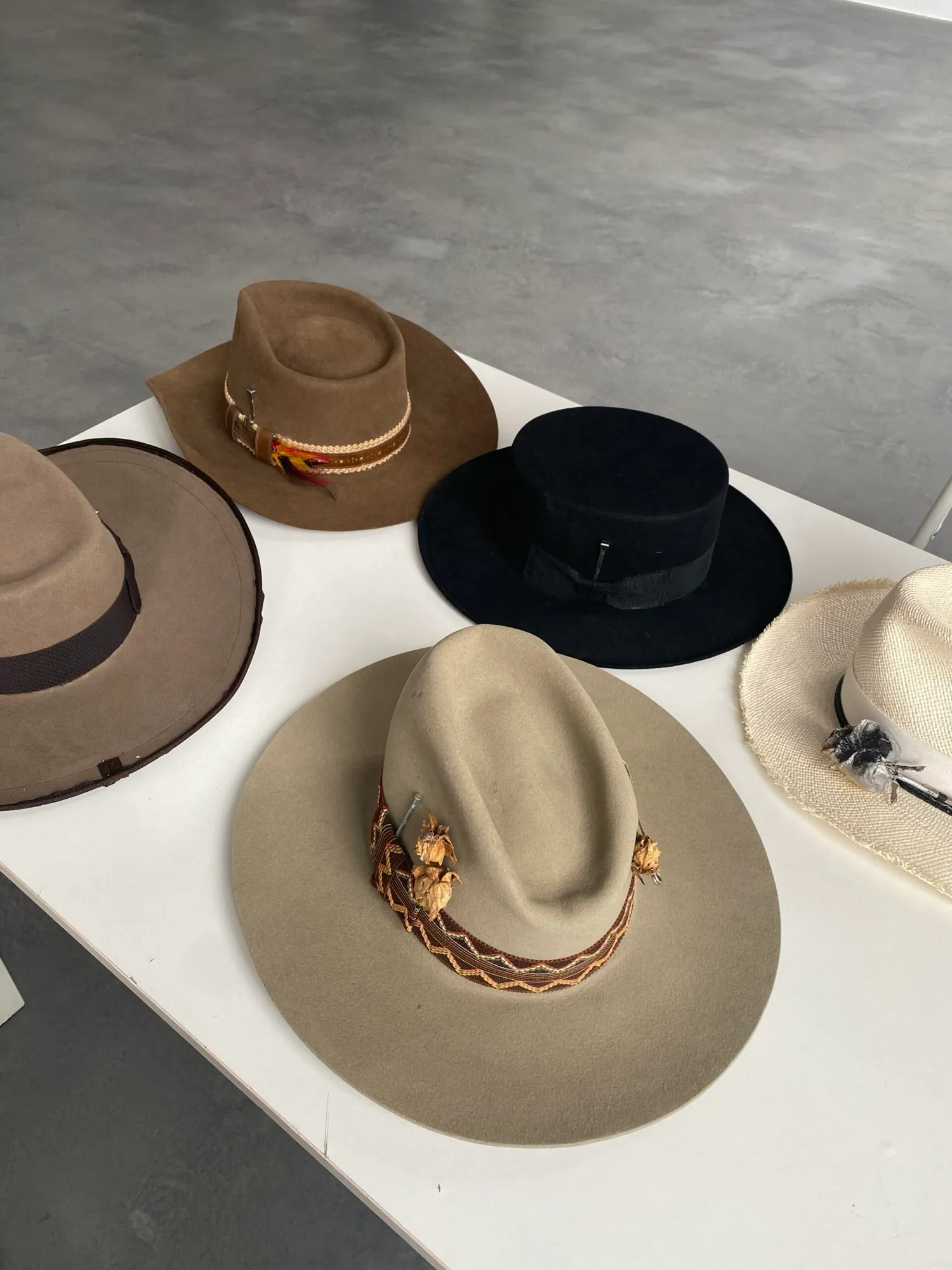 Hats laid out on a white table