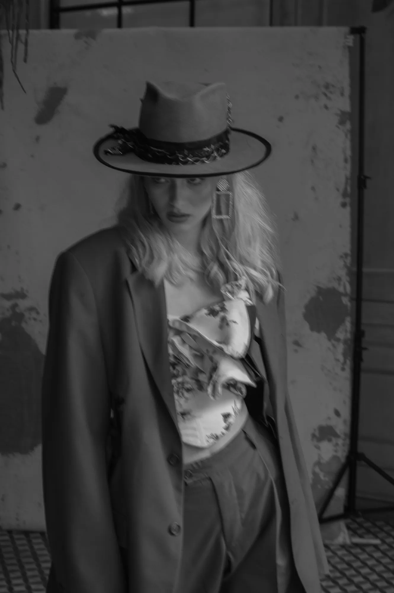 Woman in a hat and coat in the studio, black and white