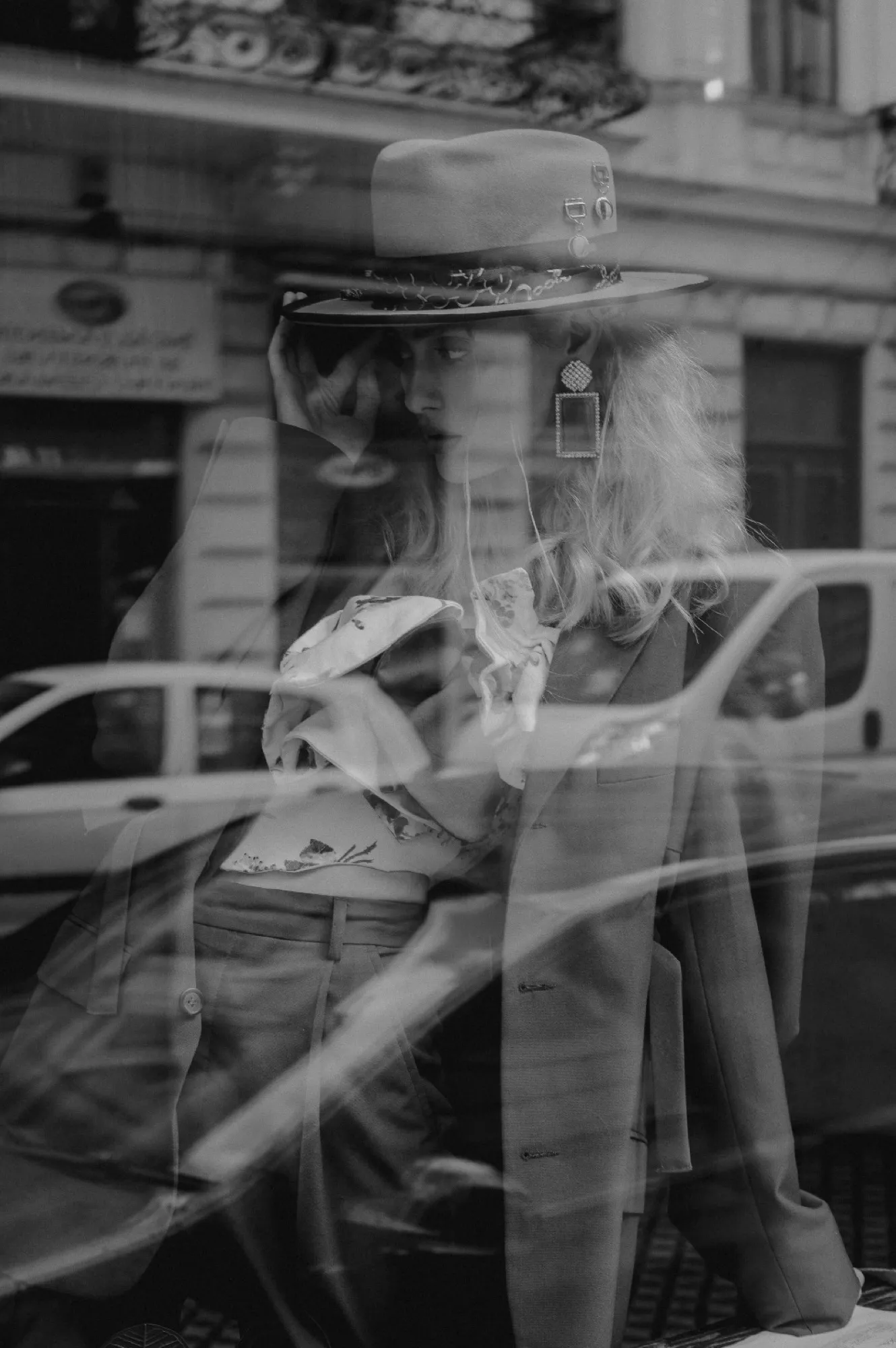 A hat reflected in a shop window, black and white